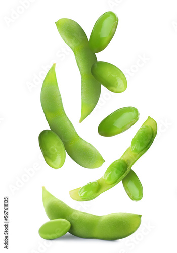 Delicious cooked soy beans and pods falling on white background. Edamame