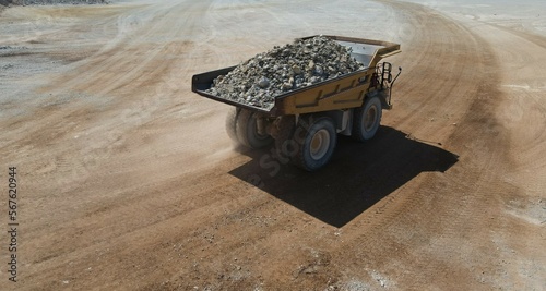 Large quarry dump truck full of stones. Transporting the ore into the crusher. Mining truck mining machinery, transport the material for production.