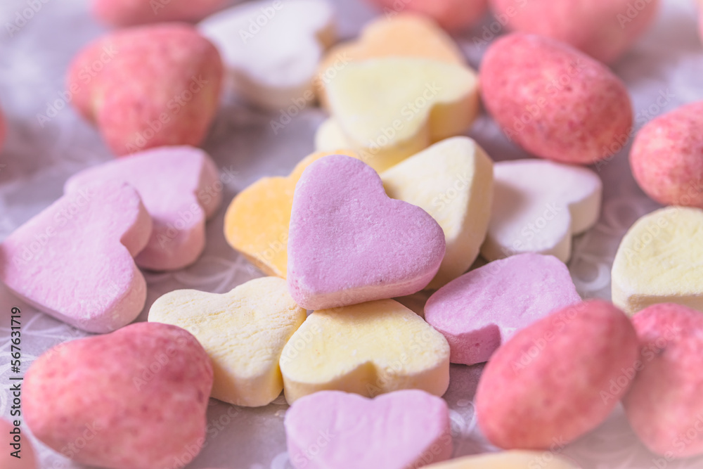 An assortment of sugar and pink chocolate hearts, top view, pastel colors An assortment of sugar and pink chocolate hearts, top view, pastel colors