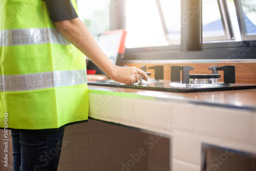 Professional home Inspector surveyor checking gas stove system at new house property