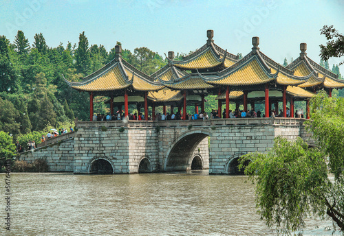 Wuting Bridge in Slender West Lake in sunny days. Chinese characters on the bridge translated as “Lotus Bridge”, which is another name of this bridge