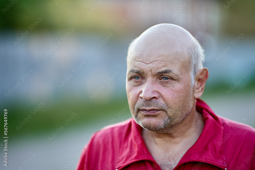 Baldheaded man in his 60s looks ahead sadness. Baldheaded man in his 60s looks ahead sadness.