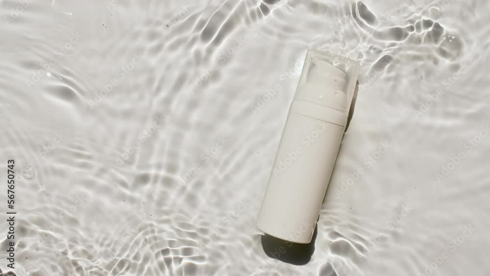 Cosmetic cream, bottle of lotion, serum, micellar toner and emulsion on water background with splashes. Cosmetic spa. Medical skin care. Advertising of a cosmetic product. High quality 4k footage. Cosmetic cream, bottle of lotion, serum, micellar toner and emulsion on water background with splashes. Cosmetic spa. Medical skin care. Advertising of a cosmetic product. High quality 4k footage.