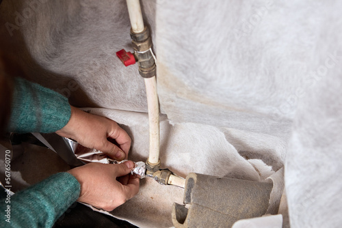 Water pipe is wrapped with heat insulating foil tape to prevent cooling and freezing during cold season.
