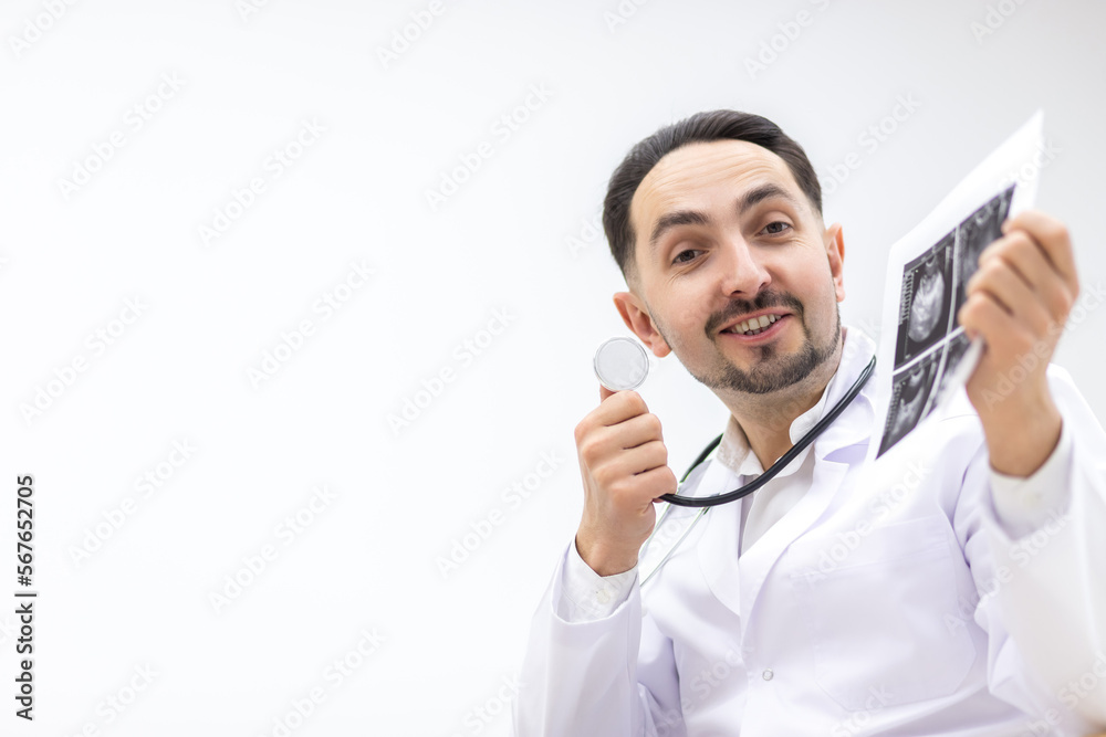 Photo of doctor wearing lab coat showing an ultrasound result to his patient. Photo of doctor wearing lab coat showing an ultrasound result to his patient.