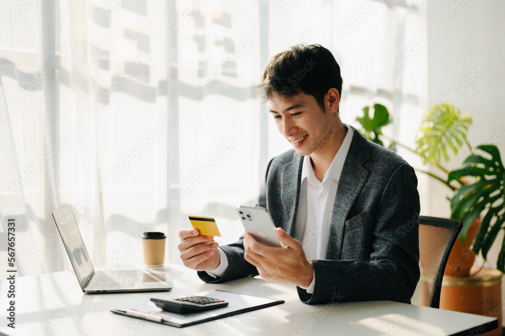 Businessman using smart phone for mobile payments online shopping,omni channel,sitting on table,virtual icons graphics interface screen in morning light. Businessman using smart phone for mobile payments online shopping,omni channel,sitting on table,virtual icons graphics interface screen in morning light.