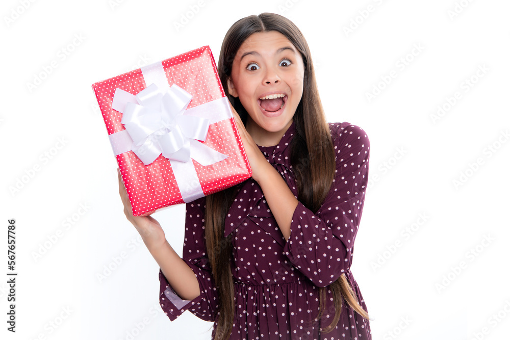 Portrait of emotional amazed excited teen girl. Surprised teenage child holding gift box on white isolated background. Gift for kids birthday. Christmas or New Year present box. Portrait of emotional amazed excited teen girl. Surprised teenage child holding gift box on white isolated background. Gift for kids birthday. Christmas or New Year present box.