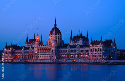 The Hungarian Parliament in Neo-Gothic style from across the Danube at blue hour. long exposure. blue sky. travel destination. Famous and popular Budapest landmark and tourist attraction. City skyline