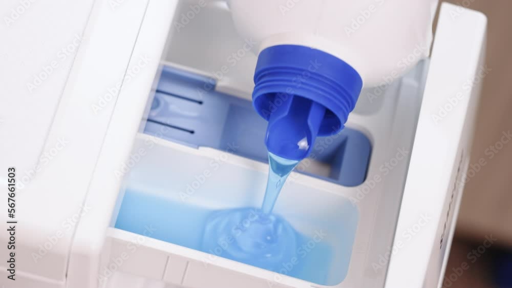 Pour some laundry detergent on the clothes and put it in the washing machine. Using fabric softener for laundry to smell good. Washing clothing in domestic washing machine