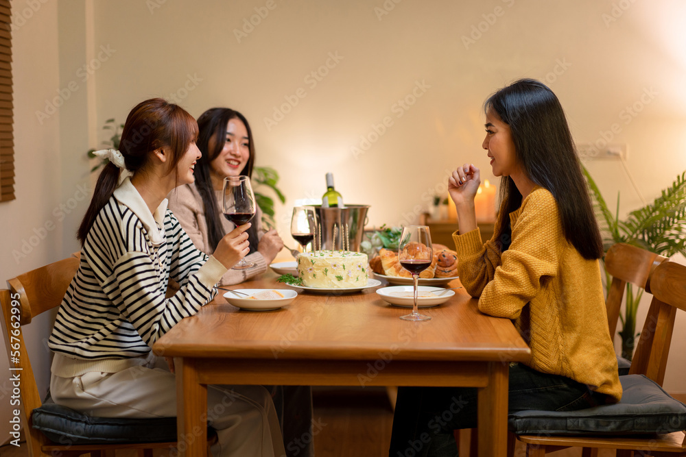 Young smiling woman drinking and clinking glass of wine to toasting with happiness while celebrating in new year party at home Young smiling woman drinking and clinking glass of wine to toasting with happiness while celebrating in new year party at home