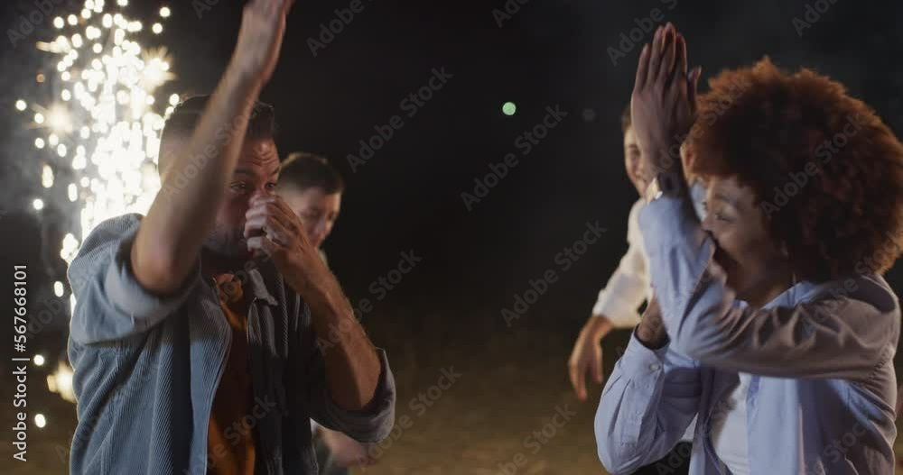 Portrait of Young Man and Woman Doing Goofy Silly Dance Moves in an Outdoors Party With Ground Sparklers. Two Multiethnic Friends Joking and Having Fun While Dancing Together and Enjoying Summer Portrait of Young Man and Woman Doing Goofy Silly Dance Moves in an Outdoors Party With Ground Sparklers. Two Multiethnic Friends Joking and Having Fun While Dancing Together and Enjoying Summer