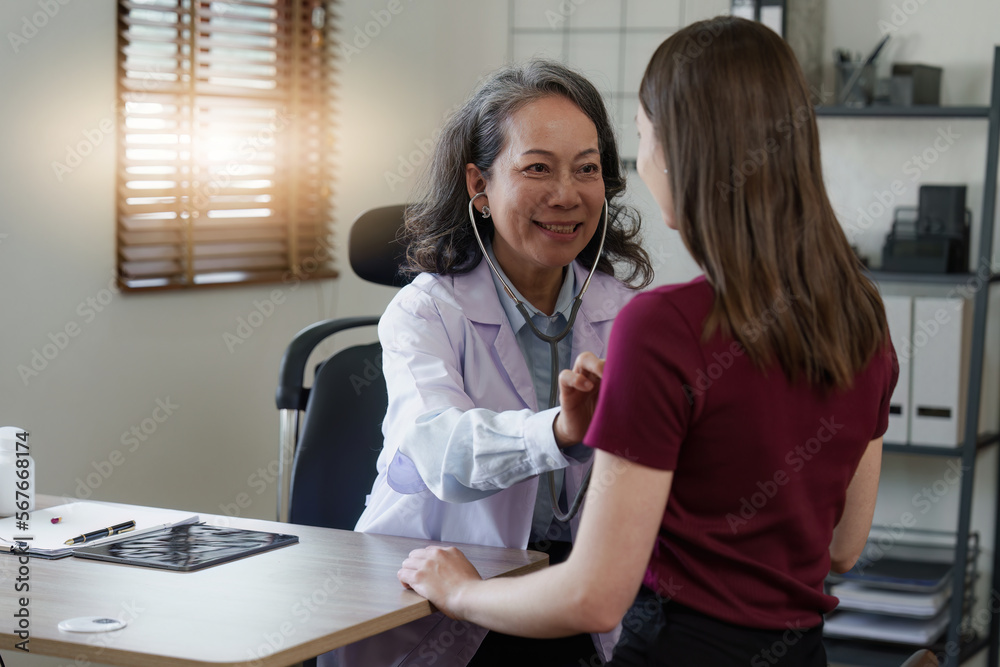 Fototapeta premium Senior Doctor and her patient. Doctor giving advice to a female patient at hospital