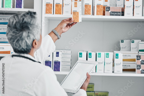 Pharmacy, tablet and mockup with senior woman in store for healthcare, wellness or retail. Product, technology and prescription with pharmacist and medicine stock for shopping, medical or inventory photo