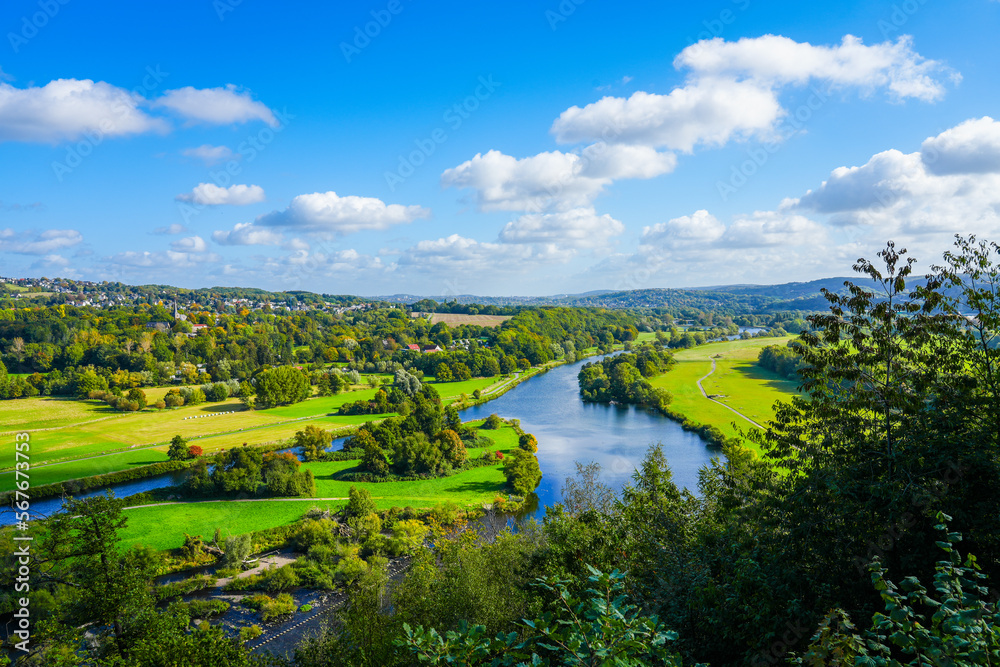 View of the Ruhr and the surrounding green landscape from the Ruhr slope. Nature on the river near Hattingen in the Ruhr area.

