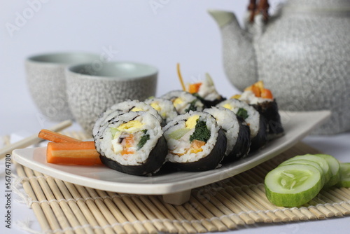 A portion of Korean Roll Gimbap ( Kimbap) homemade from Steamed White Rice (Bap) and Various other Ingredients, Such As Kyuri, Carrot, Sausage, CrabStick and Wrapped with SeaweedLaver. Selective Focus