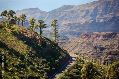 Red car on the road to the mountains of the Roque Nublo Rural Park, Gran Canary, Canary Islands, Spain photo