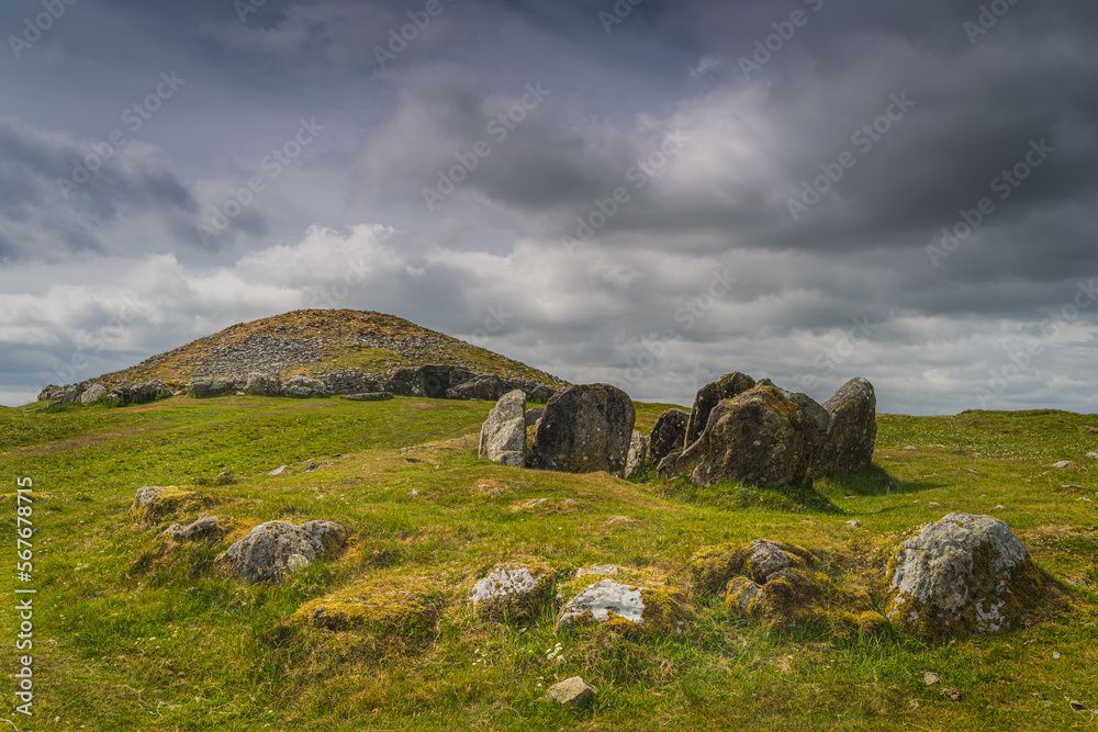 Ancient, dating back to 3000 BCE, neolithic burial chambers and stone circles of Loughcrew Cairns with dramatic, dark sky in County Meath, Ireland