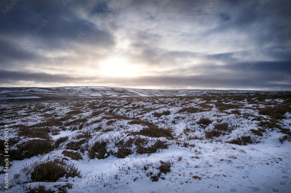 The frozen snow covered hills, countryside at sunrise of Muggleswick and Edmondbyers common, moor in winter near Blanchland, Northumberland in England UK. The frozen snow covered hills, countryside at sunrise of Muggleswick and Edmondbyers common, moor in winter near Blanchland, Northumberland in England UK.