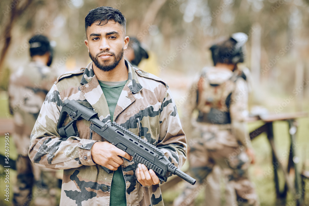 Fototapeta premium Paintball, portrait or soldier with a gun, mission or motivation on a military battlefield ready tor war. Army, mindset or man with focus, hero mindset or weapon for a fun shooting game on holiday