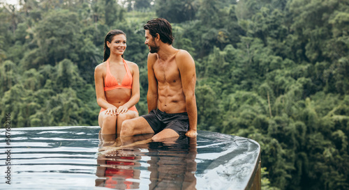 Happy young romantic couple relaxing in a swimming pool