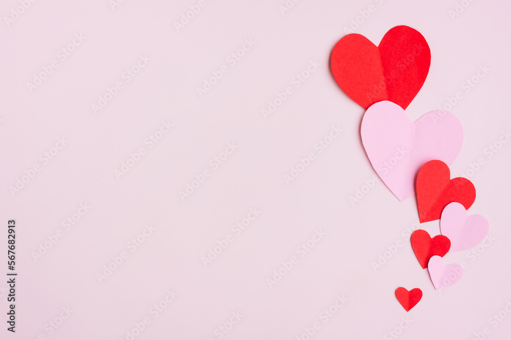 Red and Pink Paper Hearts on pink background, Heart shape papercut , Happy Valentine's day