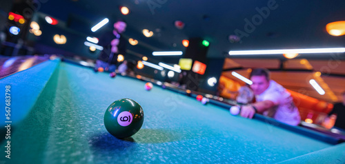 Fototapeta A game of billiards at the mall brings excitement and friendly competition to th