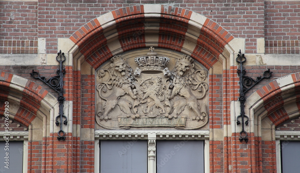 Fototapeta premium Amsterdam Historic Bushuis Building Facade Detail with Sculpted Dutch Coat of Arms, Netherlands