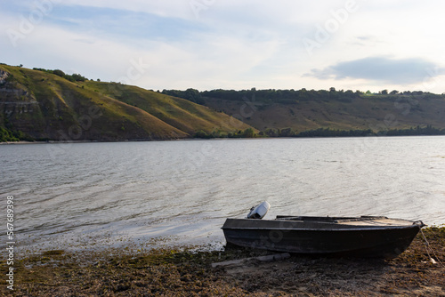 the boat stands on the bank of the river. Means of transportation on water