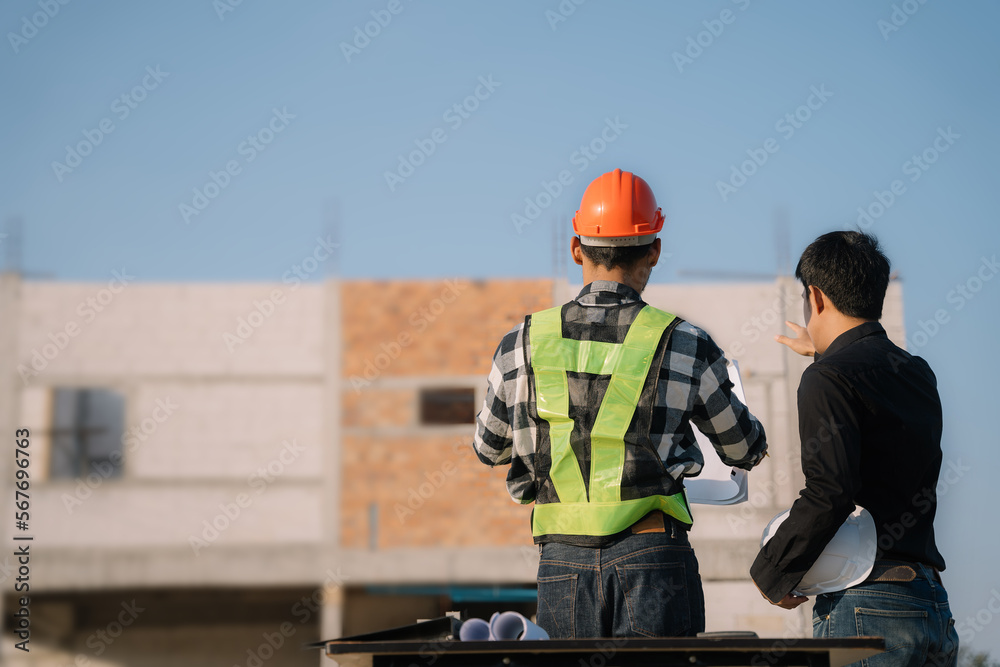 Businessman working as a team discussing data working and tablet, laptop with on on architectural project at construction site. Businessman working as a team discussing data working and tablet, laptop with on on architectural project at construction site.