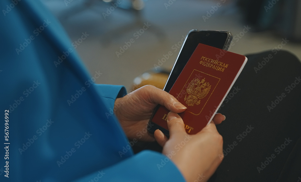 Φωτογραφία Woman with Russian Federation passport is waiting for her flight at the airport