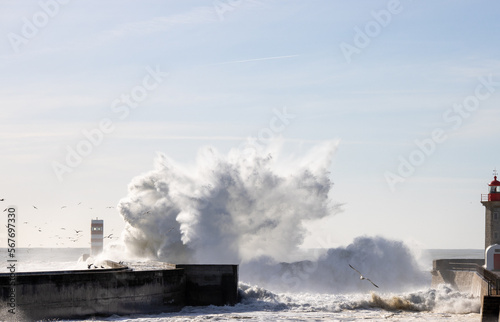 Big wave crashing over the breakwater wall in Porto  Portugal