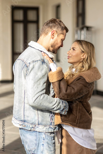 A smiling couple is in love outdoors.A young happy couple embraces on a city street. © Светлана Густова