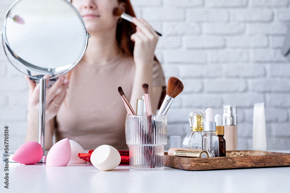 young woman making up at home, using eyeshadows young woman making up at home, using eyeshadows