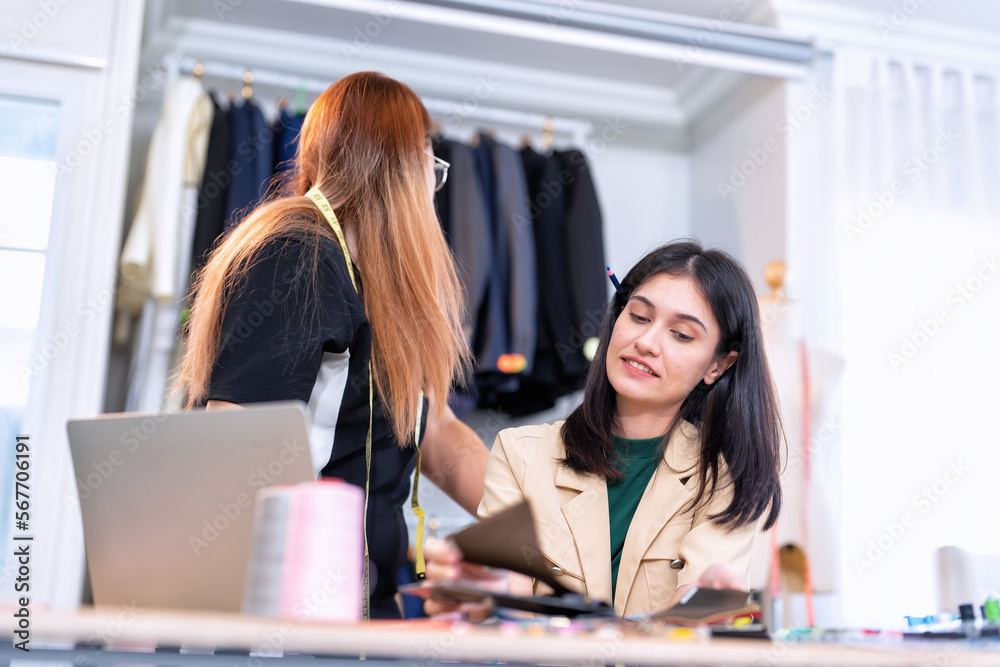 Senior fashion designer teamwork discuss teach learner final design share idea in shop lady tailor Senior fashion designer teamwork discuss teach learner final design share idea in shop lady tailor