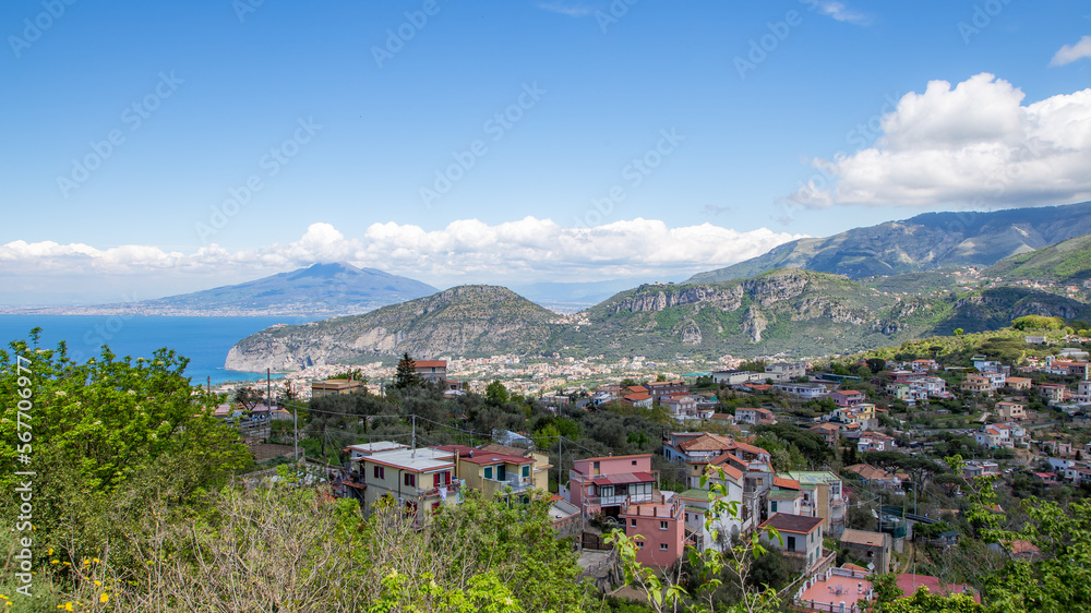 Italian mountain landscape during a sunny day with the city of Naples and the volcano Vesuvius in the background