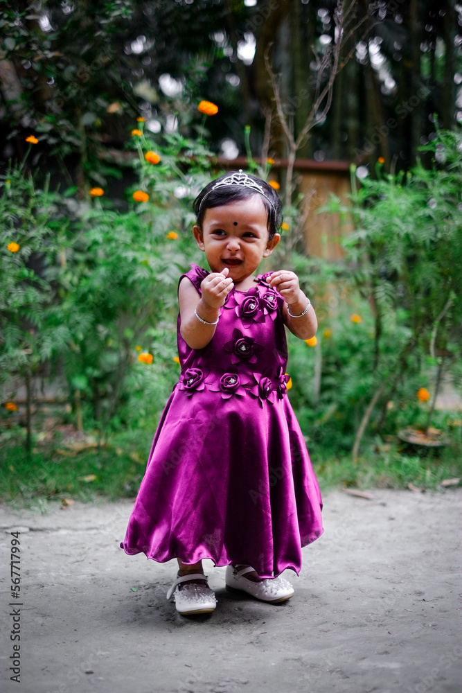 South asian little adorable cute girl on her first birthday, baby girl in princess dress, kid playing outside South asian little adorable cute girl on her first birthday, baby girl in princess dress, kid playing outside