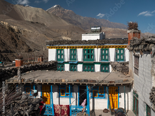 Kagbeni, Annapurna Circuit, Nepal. Colourful house with aluminium water tank and rugs hanging to dry. Upper Mustang in the background.