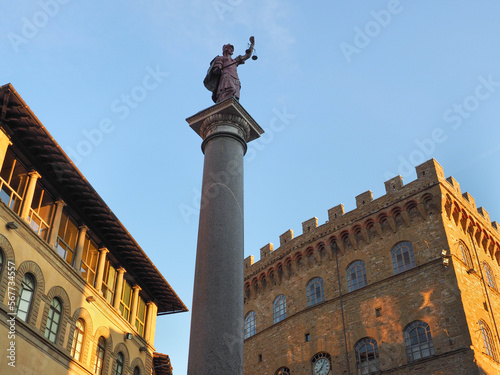 Ancient Roman victory column. Column of Justice or Colonna della Giustizia, pink porphyry statue di Santa Trinita or della Battaglia di Montemurlo in the public triangular square Piazza Santa Trinita. photo