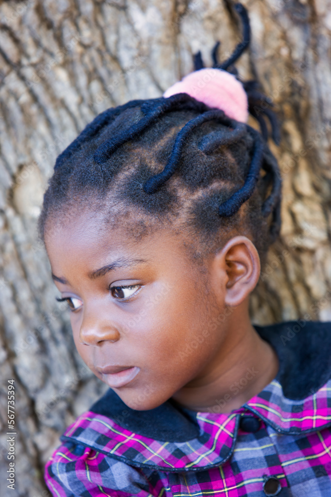african girl with natural dreadlocks standing in the garden african girl with natural dreadlocks standing in the garden