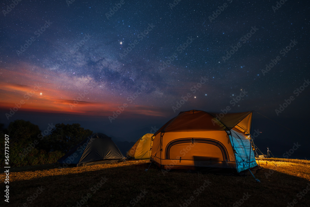 Milky way over tent locating on mountain view between the hiking route to Doi pui ko, Mae hong son, Thailand.