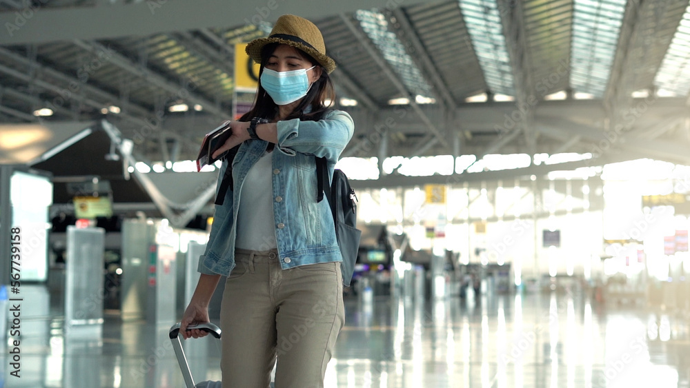 Asian traveler woman walking in airport terminal Asian traveler woman walking in airport terminal