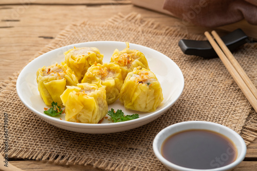 Shumai or Chinese Steamed Dumpling,meatball dumpling with wanton skin in with plate,served with soy sauce