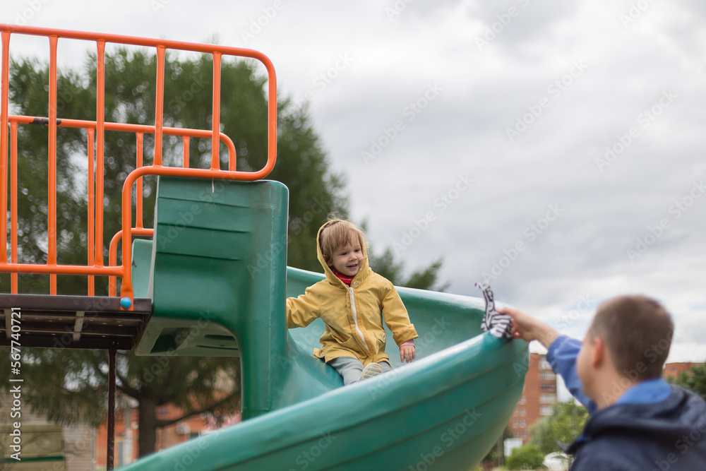 Little girl going down the slide at the playground