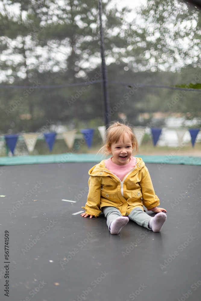 Little girl jumping on trampoline outdoors Little girl jumping on trampoline outdoors