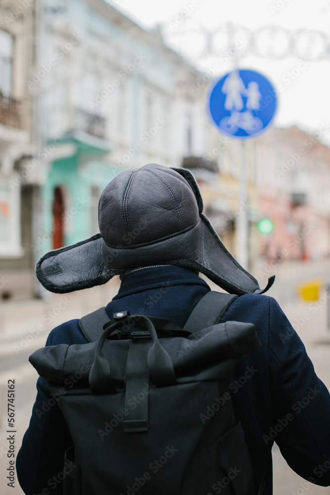 Senior man enjoying a walk in the winter city on the weekend. The concept of city life and recreation.