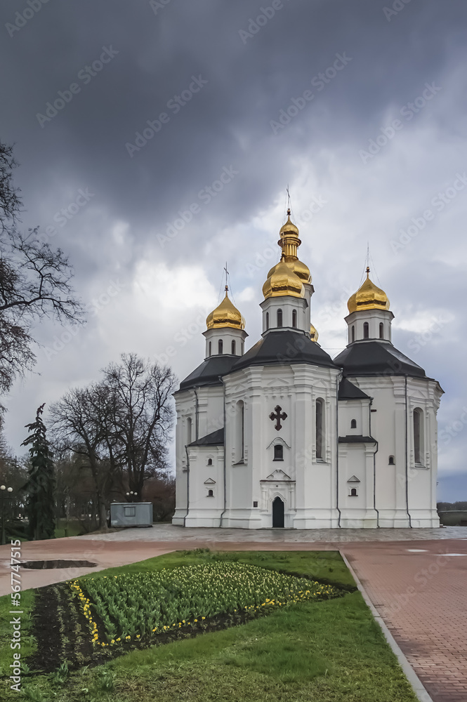 View from the city park of the city of Chernihiv to an Orthodox church with golden domes, in cloudy spring weather