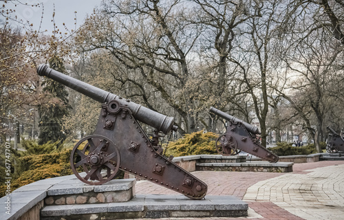 Ancient steel heavy cannons in the city park of the city of Chernihiv, monuments from cannons in cloudy weather