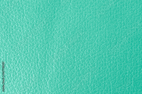 The Texture of genuine grainy leather of light mint green color for wallpaper or banner design. Fashionable modern background, copy space