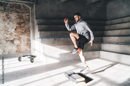 Sportsman working out on step platform photo