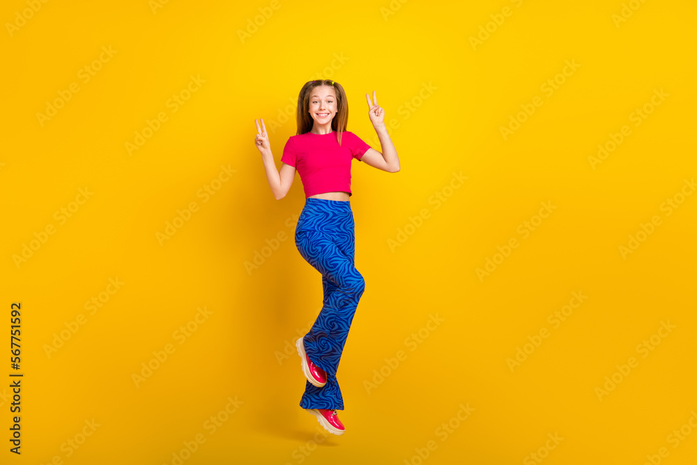 Photo of cheerful funky crazy lady wear stylish outfit have fun hand demonstrate v-sign empty space isolated on yellow color background Photo of cheerful funky crazy lady wear stylish outfit have fun hand demonstrate v-sign empty space isolated on yellow color background